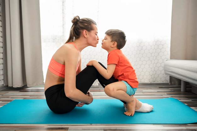 Beautiful mother exercising with son