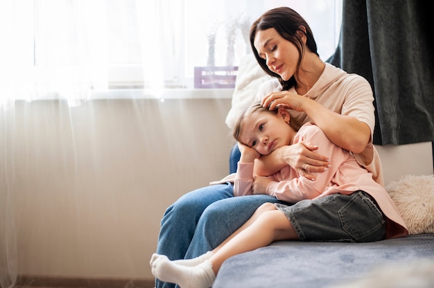 Free photo beautiful mother holding her daughter