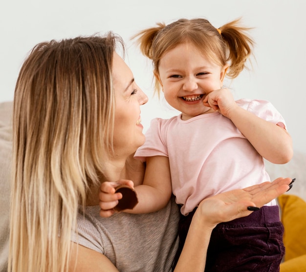 Beautiful mother spending time together with her daughter at home