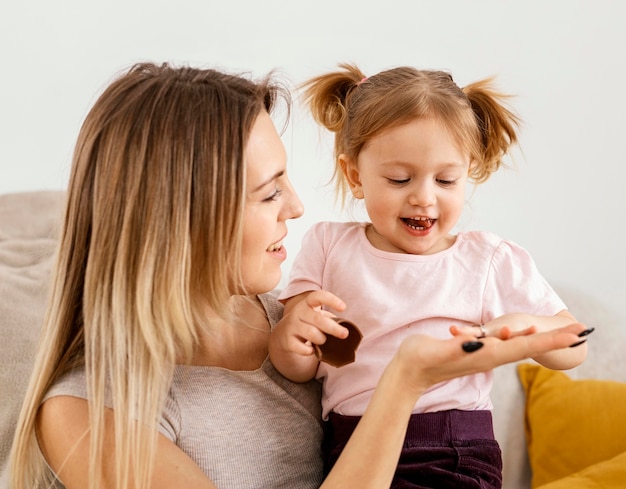 Beautiful mother spending time together with her daughter at home