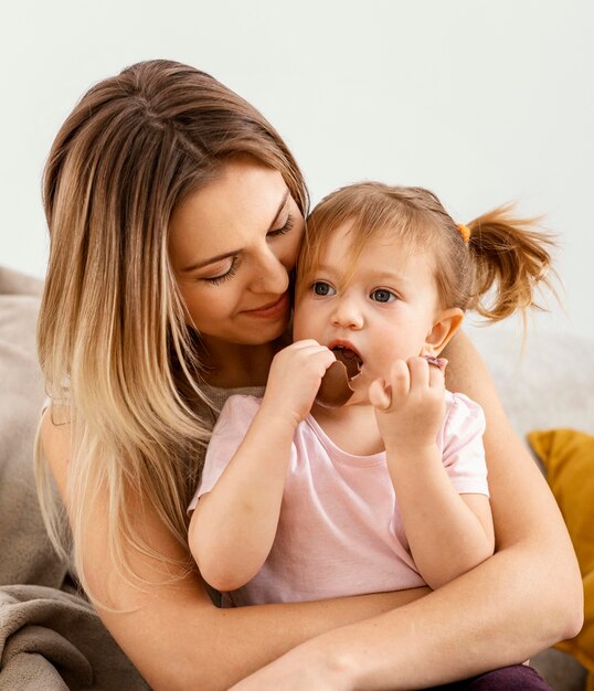 Beautiful mother spending time together with her daughter at home