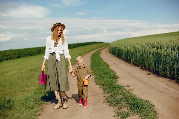 Beautiful mother with little son in a summer field