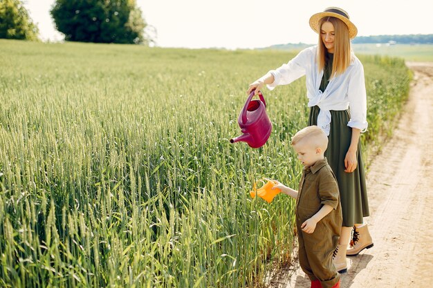 Beautiful mother with little son in a summer field