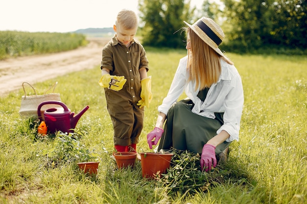 Beautiful mother with little son in a summer field