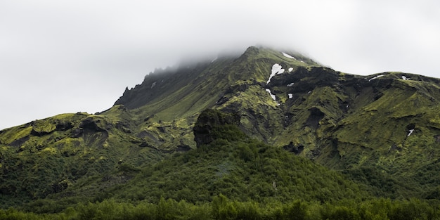 Free photo beautiful mountain range covered with snow enveloped in fog - great for a natural wallpaper