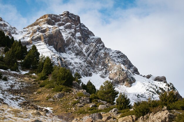 Beautiful mountain range covered with snow enveloped in fog