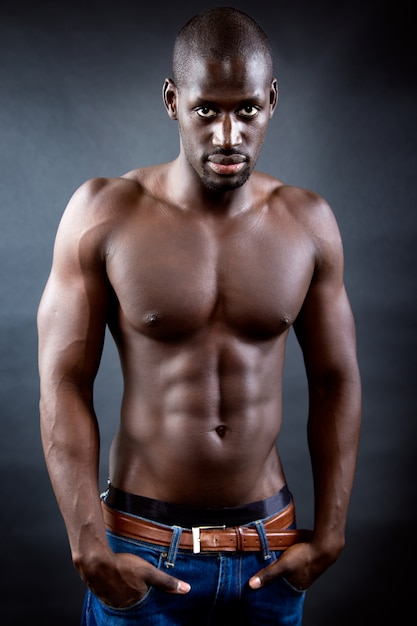 Free photo beautiful and muscular man in dark background.