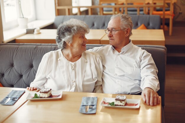 Beautiful old couple sitting in a cafe