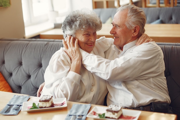 Beautiful old couple sitting in a cafe