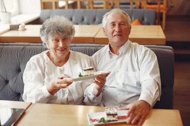 Beautiful old couple sitting in a cafe