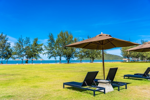 Beautiful outdoor landscape of sea and beach with umbrella and chair