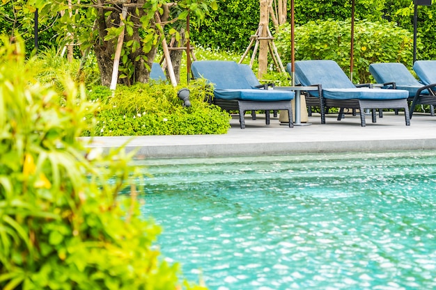 Beautiful outdoor swimming pool in hotel and resort with chair and deck for leisure vacation