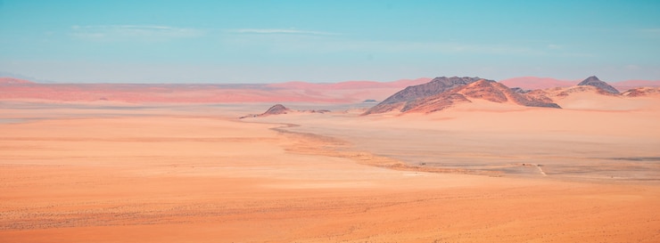 Free Photo beautiful panoramic high angle shot of namib desert mountains in kanaan, namibia