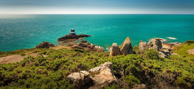 Beautiful panoramic shot of cliffs with a calm sea