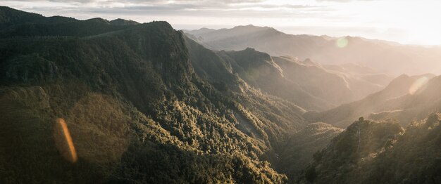 Beautiful panoramic shot of mountains and rocky cliffs and natural fog