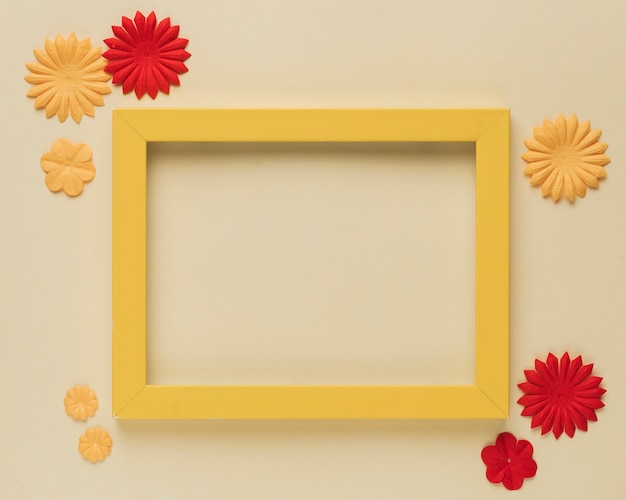 Beautiful paper flower cutout and wooden frame border on beige background