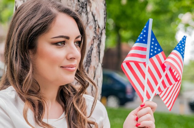 Beautiful patriotic young woman with the American flag