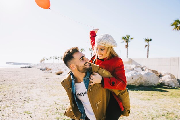 Beautiful people in love posing on shore