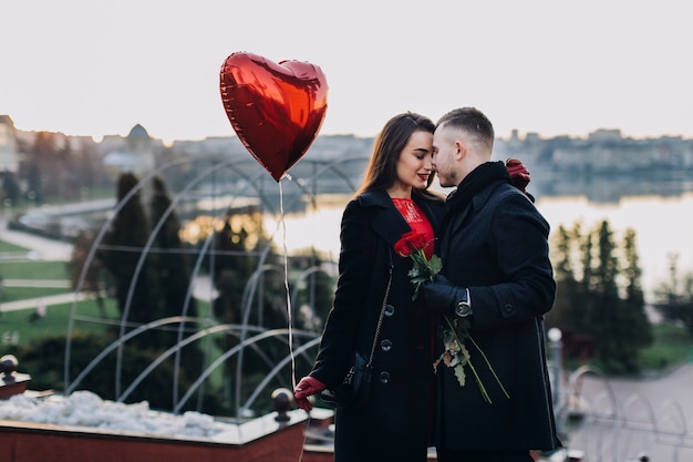 Free photo beautiful people with red heart on street