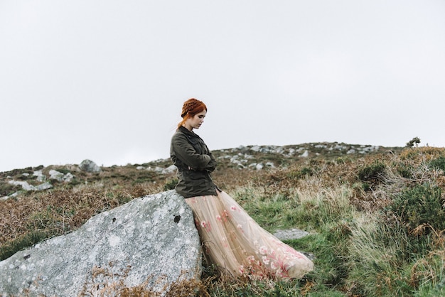 Beautiful picture of a ginger female with a pure white skin in an attractive light pink gown