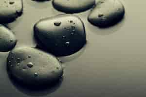 Free photo beautiful picture of spa hot stones, view from above. dark background. top. spa concept. side composition.