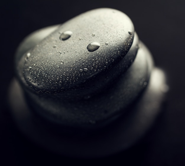 Beautiful picture of Spa Hot Stones, View from Above. Dark Background. Top. Spa Concept.