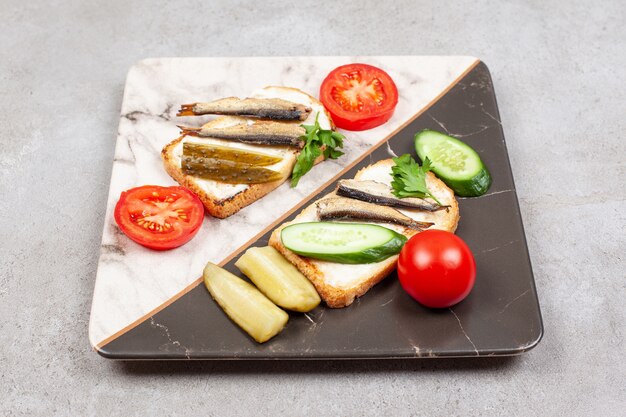 A beautiful plate with fried toasts and sprats 