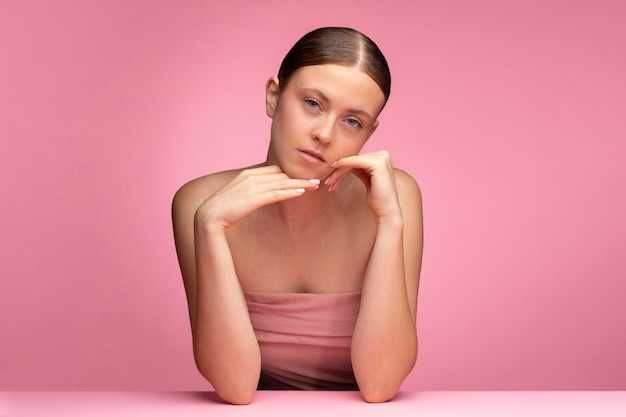 Beautiful portrait of woman on pink