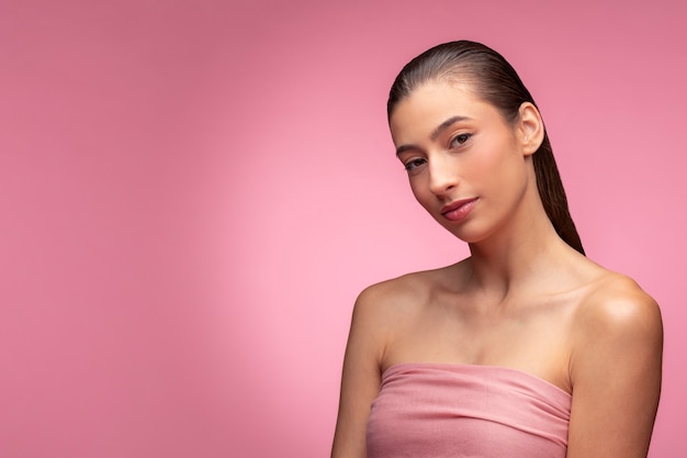 Beautiful portrait of woman on pink