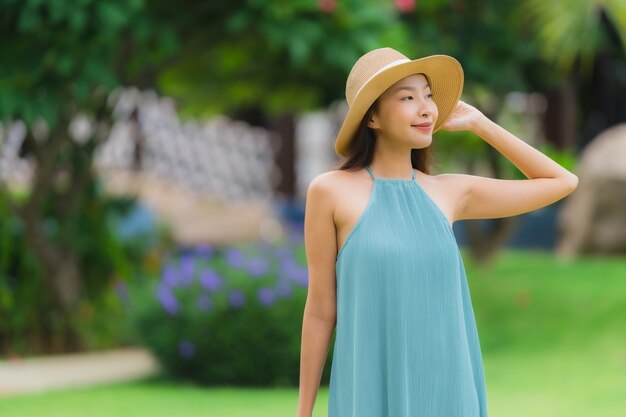 Beautiful portrait young asian woman happy smile relax with walk in the garden