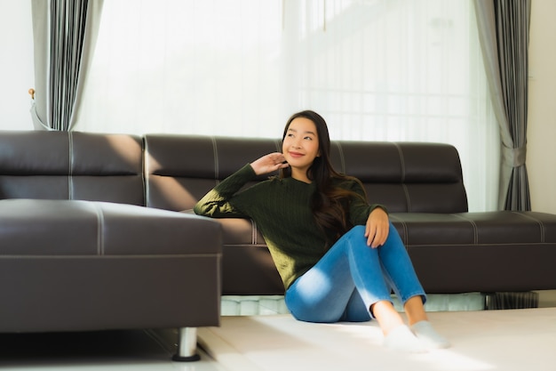 Beautiful portrait young asian woman sit relax on sofa