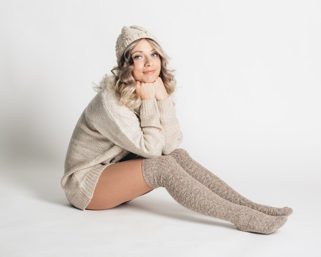 Beautiful portrait of young attractive woman in knitted clothes