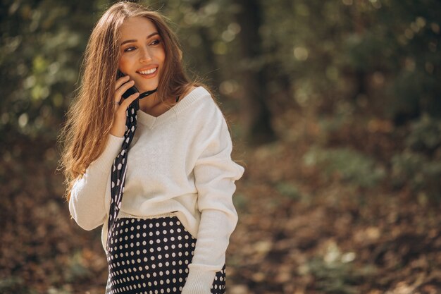 Beautiful pregnant woman in an autumn park