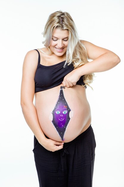 Beautiful pregnant woman with baby painted on belly.