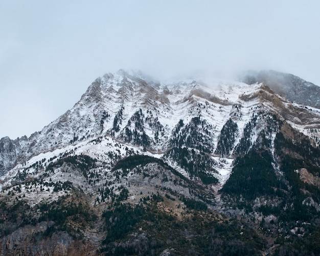 Beautiful range of high rocky mountains covered with snow during daytime