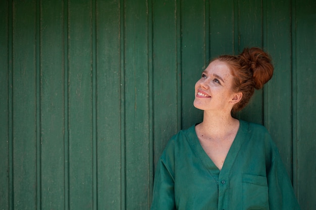 Free photo beautiful redhead woman looking away