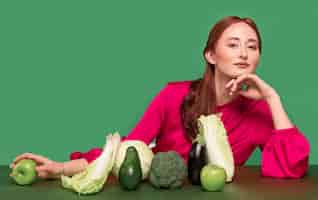 Free photo beautiful redhead woman portrait with vegetables