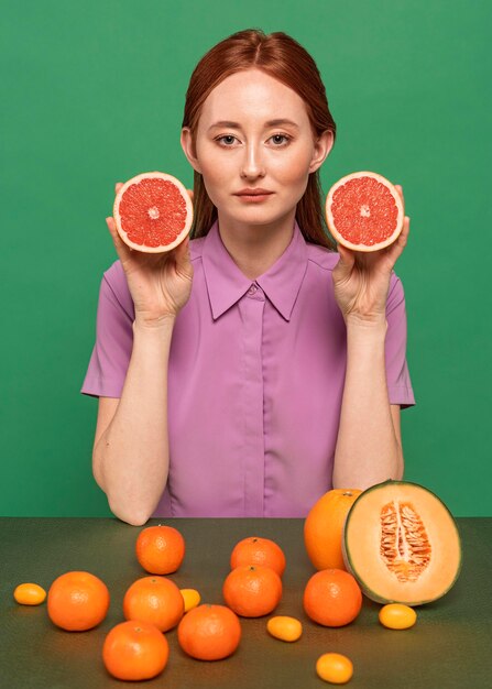 Beautiful redhead woman posing with fruits