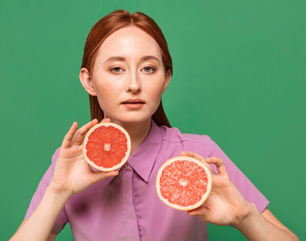 Beautiful redhead woman posing with fruits