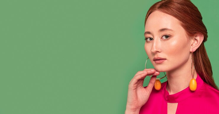 Free Photo beautiful redhead woman wearing fruit earrings