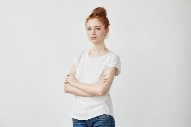 Beautiful redhead woman with crossed arms.