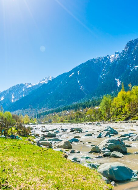 Beautiful  River and snow covered mountains landscape Kashmir state, India .