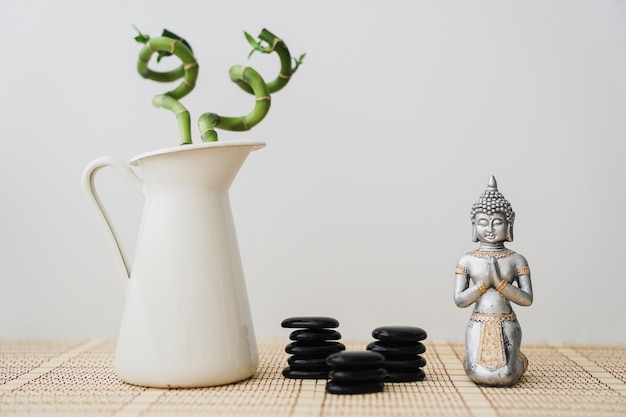 Beautiful scene with volcanic stones, buddha and bamboo