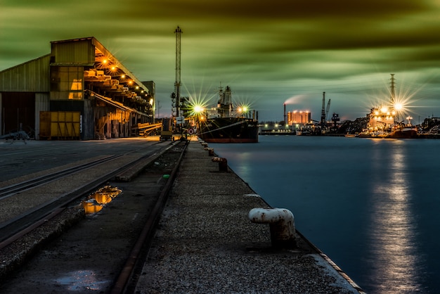 Beautiful scenery of buildings with lights near the lake under the breathtaking sky