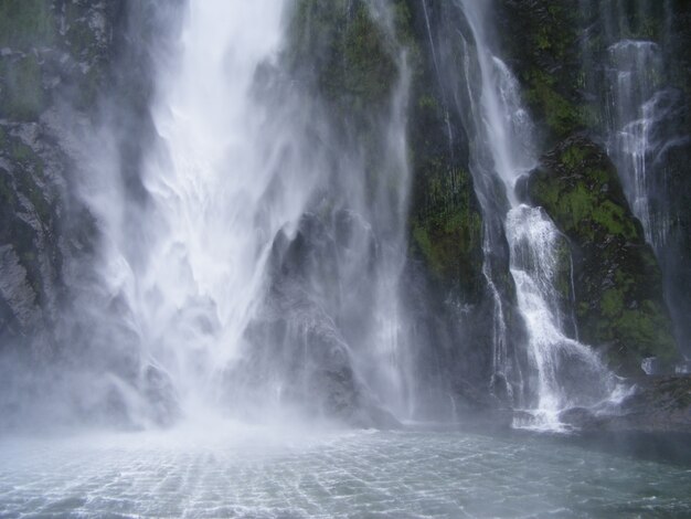 Beautiful scenery of a powerful waterfall in New Zealand Fjords