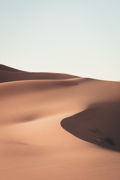 Beautiful scenery of sand dunes in a desert area on a sunny day