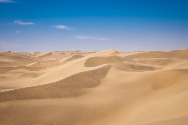 Beautiful scenery of sand dunes in a desert on a sunny day