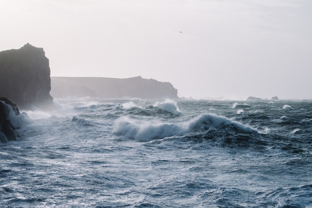 Beautiful scenery of sea waves crashing over rock formations