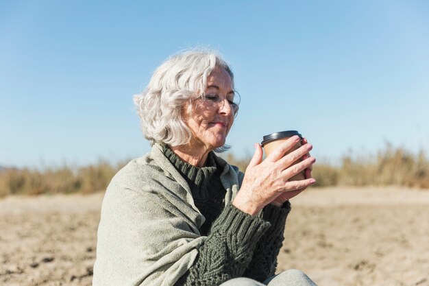 Beautiful senior lady holding coffee