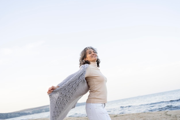 Beautiful senior woman enjoying her time at the beach